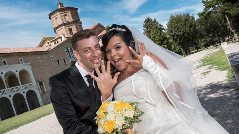 Sposi mostrano le fedi sfondo con Loggetta Lombardesca